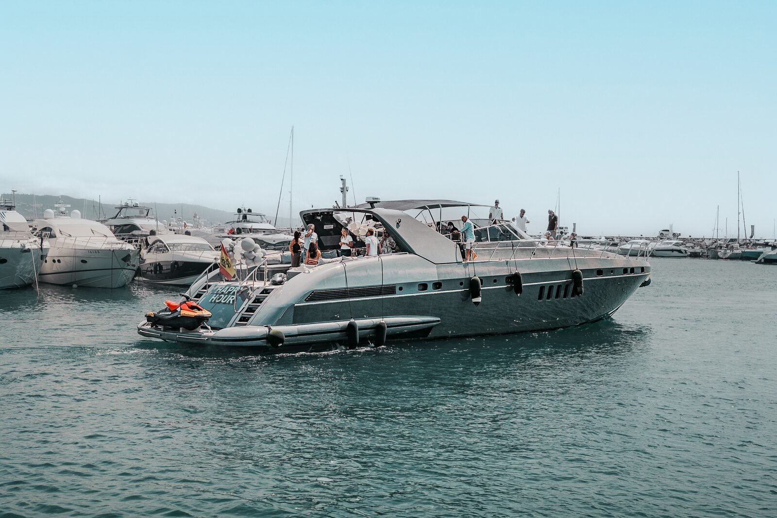Happy Hour Mangusta 80 leaving Puerto Banus marina with guests on board